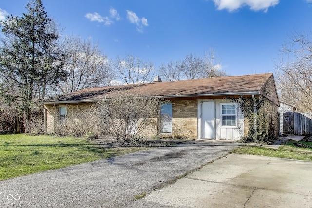 7906 E 21st St, Indianapolis, IN 46219 - ranch-style home featuring brick siding and a front yard