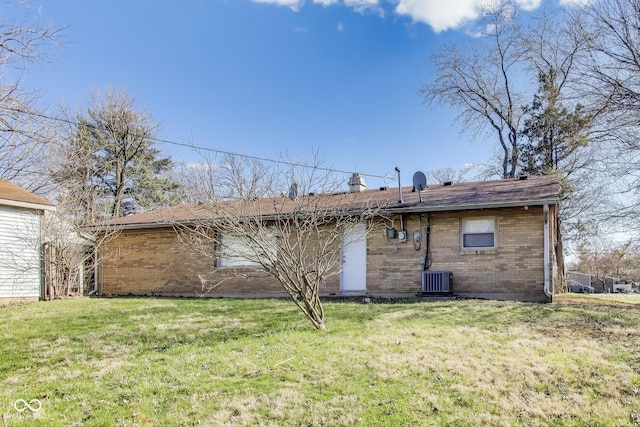 7906 E 21st St, Indianapolis, IN 46219 - back of house featuring a lawn, cooling unit, and brick siding