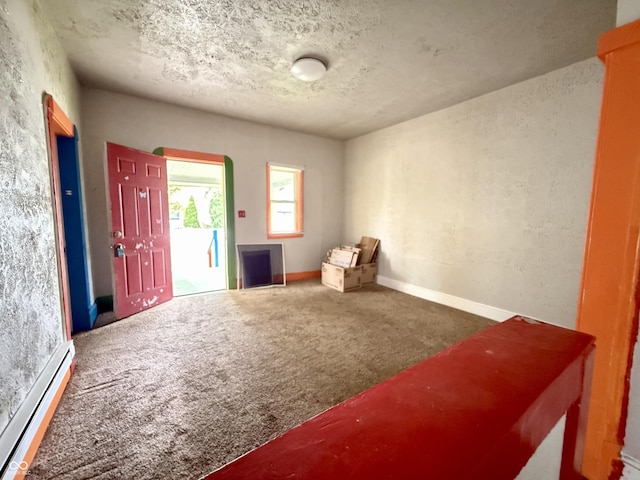 sitting room featuring baseboards, baseboard heating, and carpet