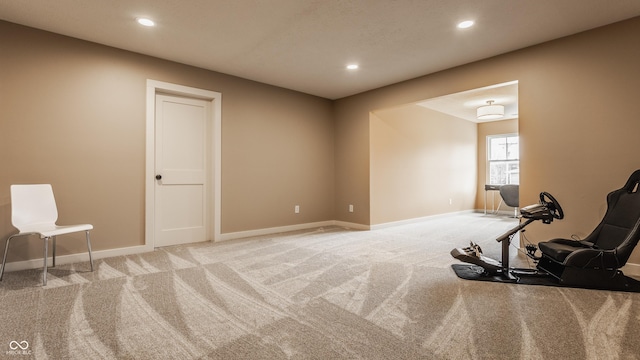 exercise area with baseboards, recessed lighting, and light colored carpet