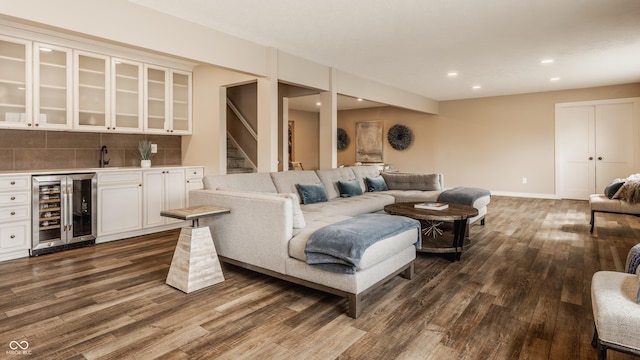 living area featuring dark wood finished floors, indoor wet bar, recessed lighting, and beverage cooler
