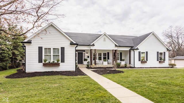 view of front of home with covered porch and a front lawn