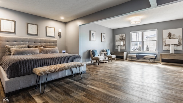 bedroom with baseboards and dark wood-type flooring