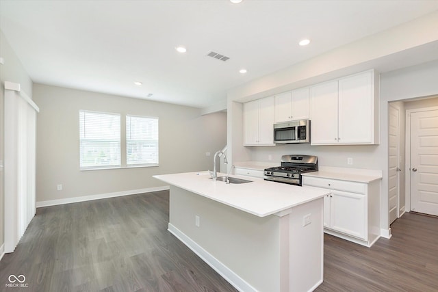 1239 Newton St, Avon, IN 46123 - kitchen featuring dark wood finished floors, visible vents, a sink, a center island with sink, and stainless steel appliances