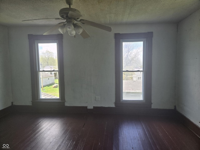 unfurnished room with a textured ceiling, a ceiling fan, and hardwood / wood-style flooring
