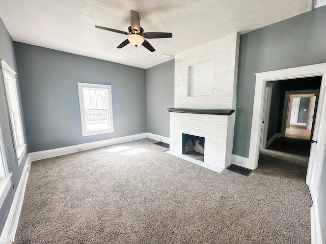 unfurnished living room with a fireplace, baseboards, carpet, and a ceiling fan