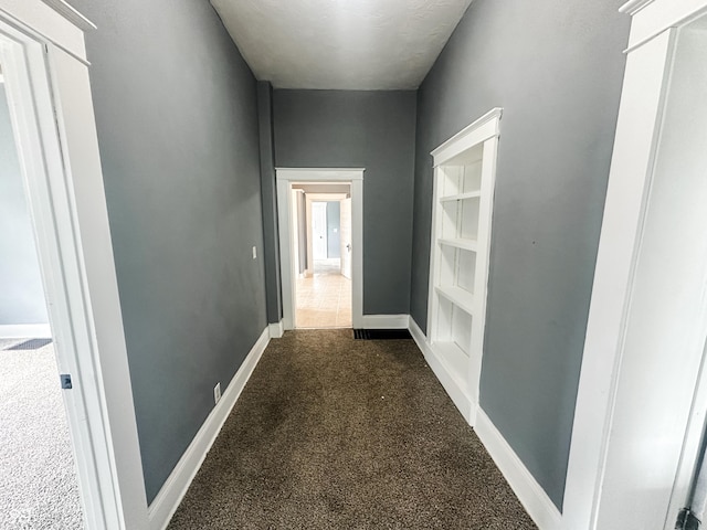 corridor featuring carpet floors and baseboards