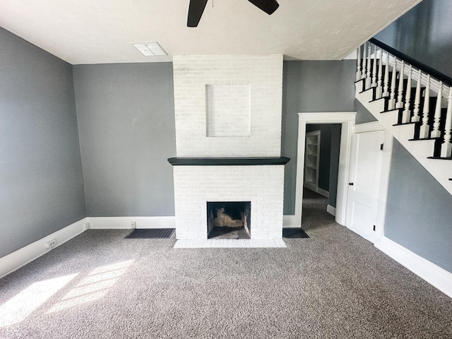 unfurnished living room with carpet floors, a fireplace, a ceiling fan, and stairs
