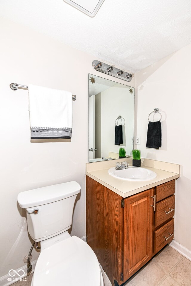 half bathroom featuring toilet and vanity