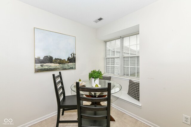 dining space featuring baseboards and visible vents