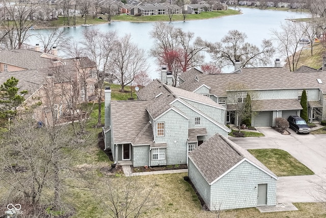 drone / aerial view featuring a residential view and a water view