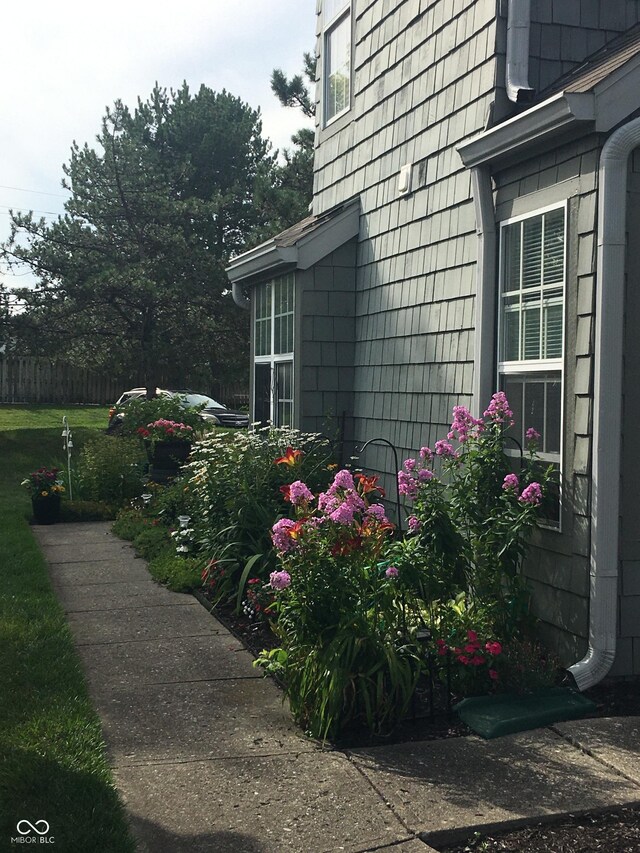 view of side of property featuring fence