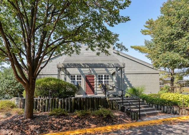 view of front of property featuring fence
