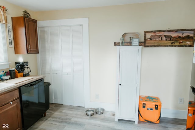 kitchen featuring light wood-style flooring and dishwasher