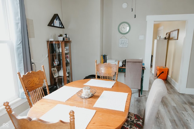dining room featuring baseboards and light wood-style floors