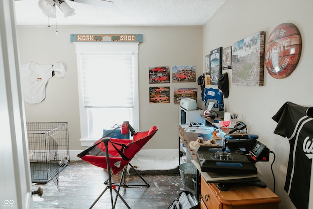 interior space with a textured ceiling and a ceiling fan