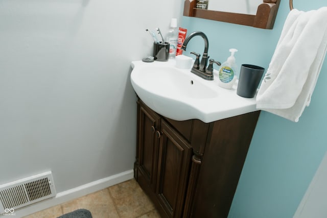bathroom with baseboards, visible vents, tile patterned floors, and vanity