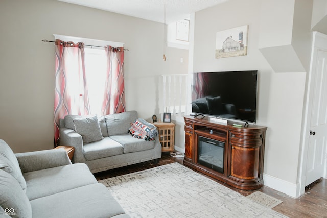 living room with baseboards and wood finished floors