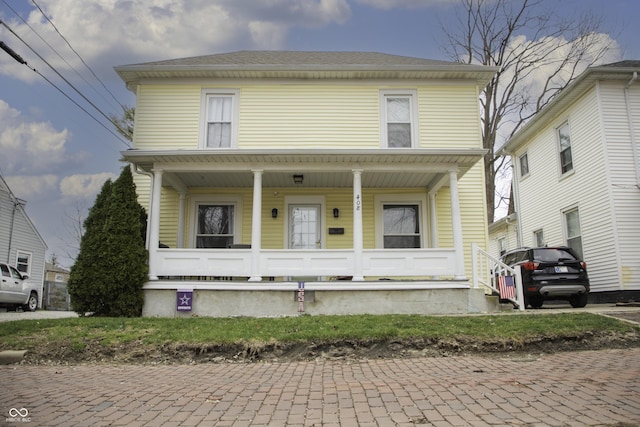 traditional style home featuring covered porch