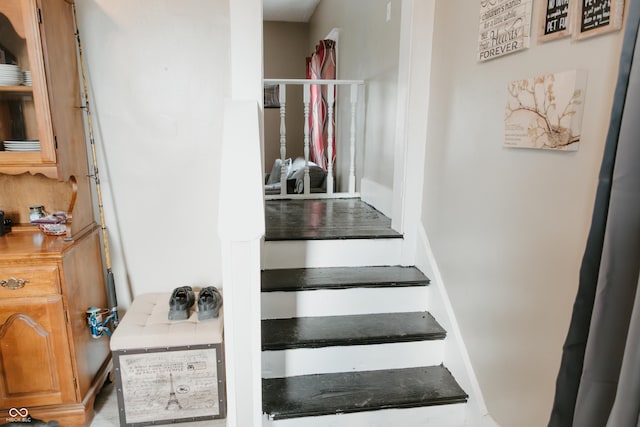stairway featuring baseboards