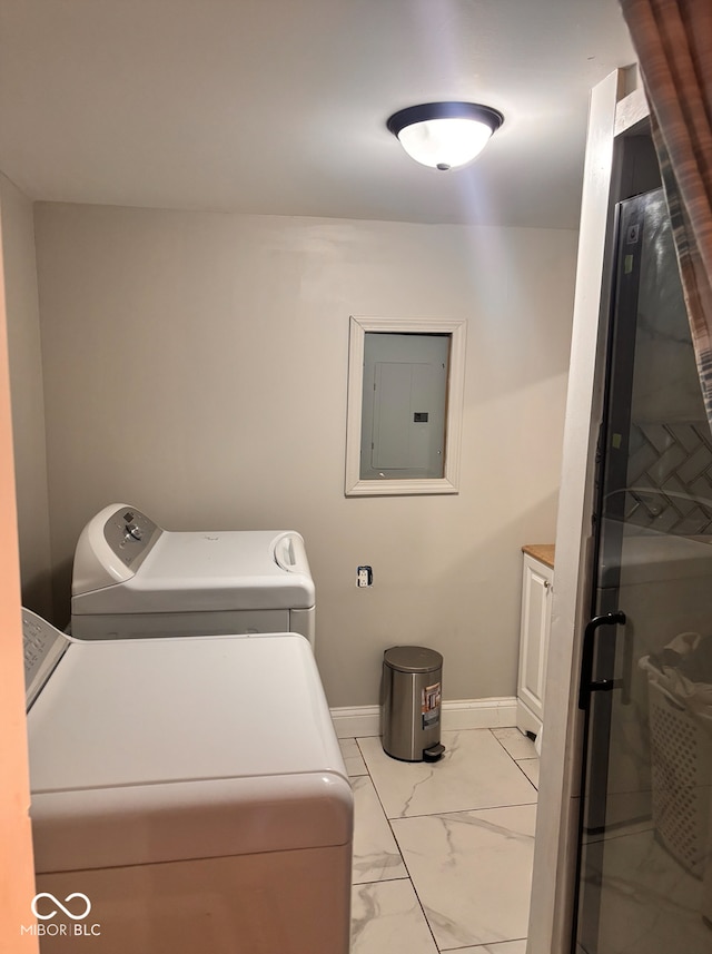 laundry room featuring washer and clothes dryer, baseboards, marble finish floor, cabinet space, and electric panel