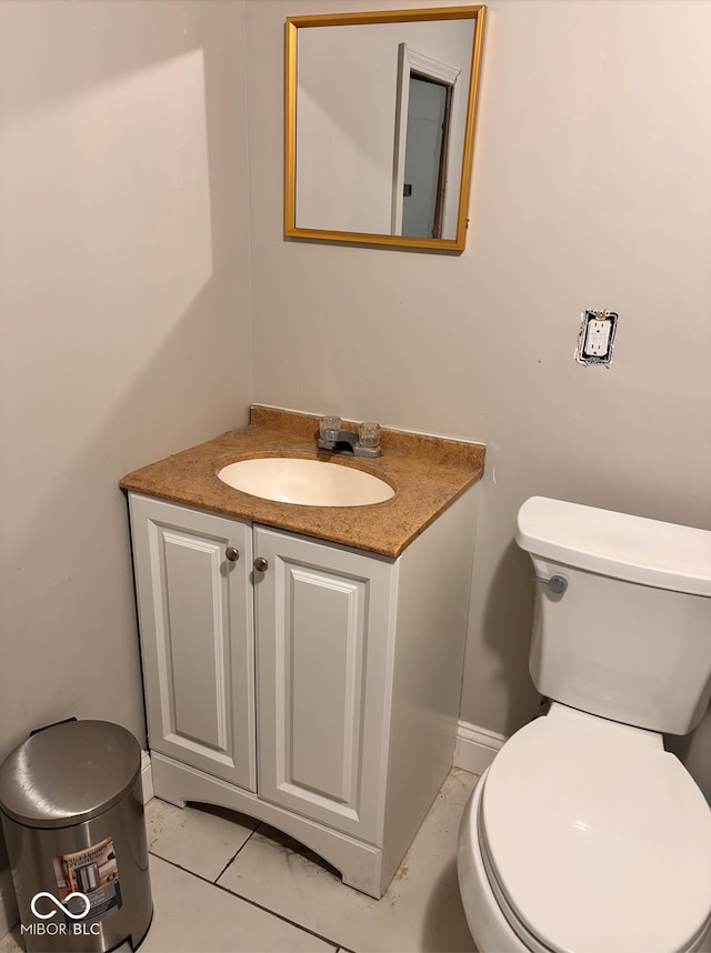 bathroom featuring baseboards, toilet, and vanity