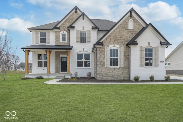 6609 N Dogwood Dr, Mccordsville, IN 46055 - french provincial home with stone siding, covered porch, a shingled roof, and a front lawn