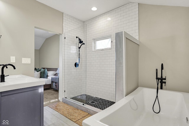 934 E Minnesota St, Indianapolis, IN 46203 - ensuite bathroom featuring tile patterned flooring, a tile shower, vaulted ceiling, ensuite bath, and a freestanding bath