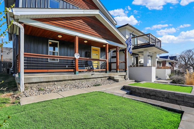 934 E Minnesota St, Indianapolis, IN 46203 - view of front of property with covered porch, a balcony, and a front yard