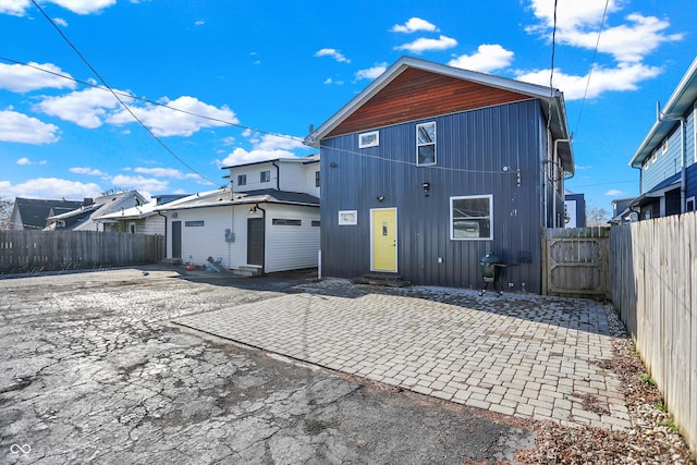 934 E Minnesota St, Indianapolis, IN 46203 - back of property featuring a patio, a fenced backyard, and entry steps