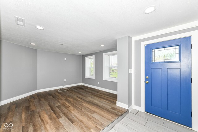 entrance foyer featuring baseboards, recessed lighting, and wood finished floors