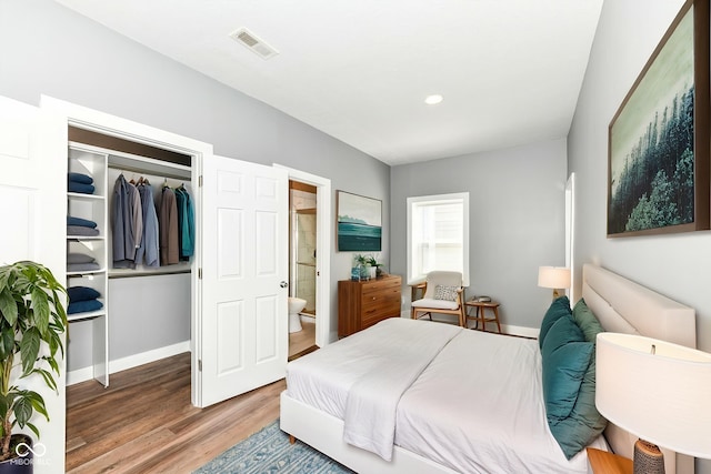 1653 S Delaware St, Indianapolis, IN 46225 - bedroom with wood finished floors, a closet, baseboards, and ensuite bathroom