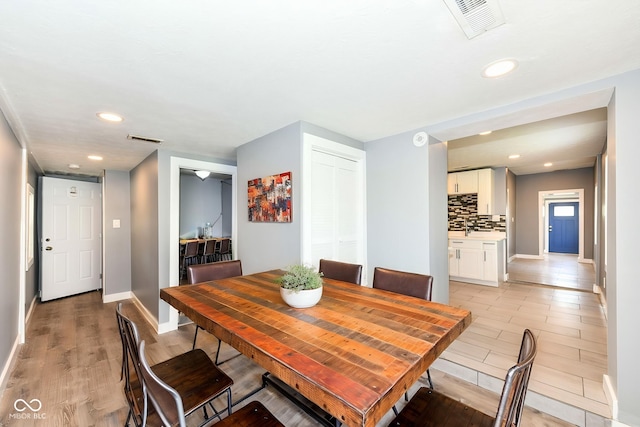 1653 S Delaware St, Indianapolis, IN 46225 - dining space featuring light wood-style flooring, baseboards, and recessed lighting