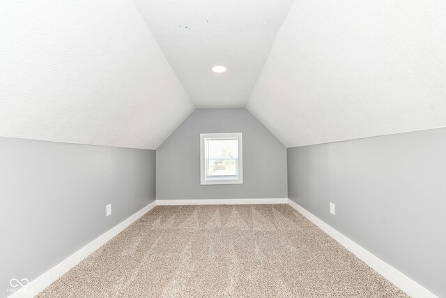 1653 S Delaware St, Indianapolis, IN 46225 - bonus room featuring baseboards, carpet, vaulted ceiling, a textured ceiling, and recessed lighting