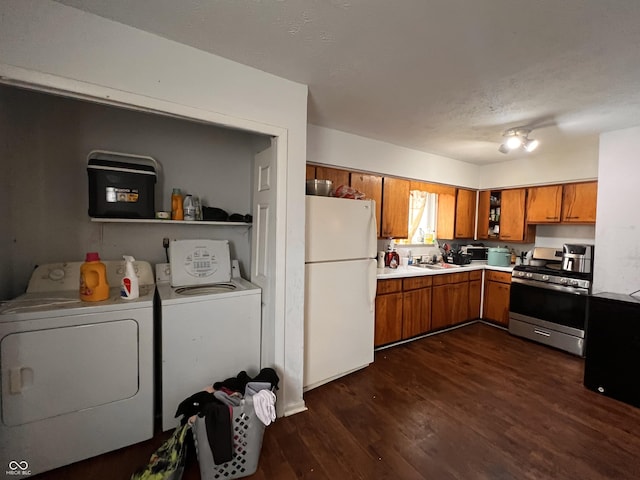 2194 N Riley Ave, Indianapolis, IN 46218 - kitchen featuring brown cabinets, washer and dryer, stainless steel range with gas stovetop, and freestanding refrigerator