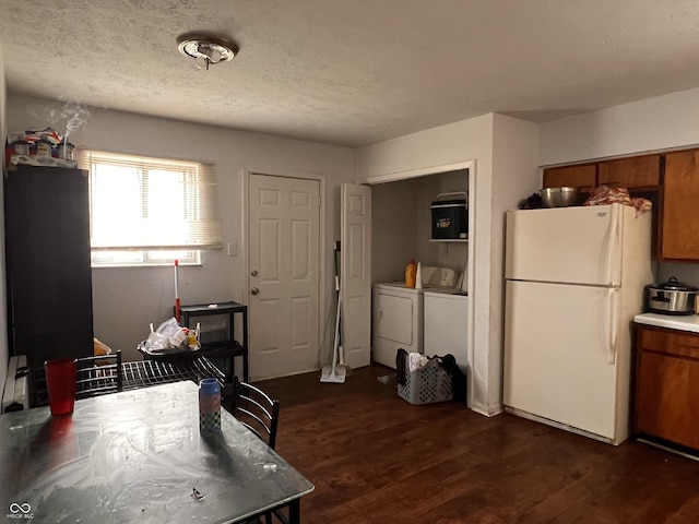 2194 N Riley Ave, Indianapolis, IN 46218 - kitchen with washer and clothes dryer, freestanding refrigerator, a textured ceiling, dark wood finished floors, and brown cabinets