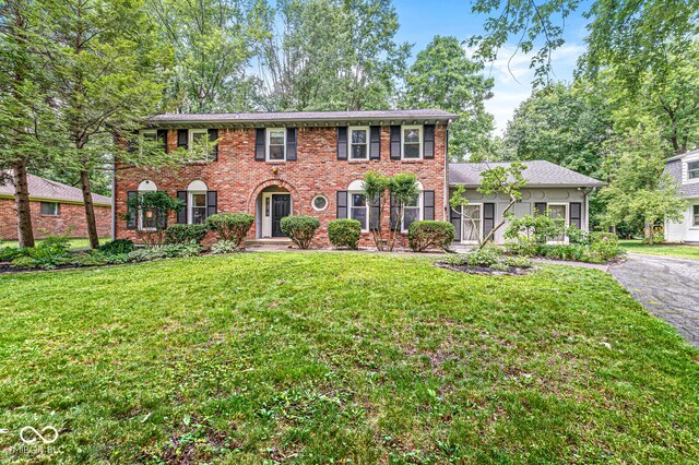 7138 Avalon Trail Ct, Indianapolis, IN 46250 - colonial home featuring a front lawn, brick siding, and driveway