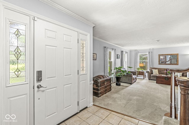 7138 Avalon Trail Ct, Indianapolis, IN 46250 - entrance foyer featuring light carpet, light tile patterned floors, a textured ceiling, and ornamental molding