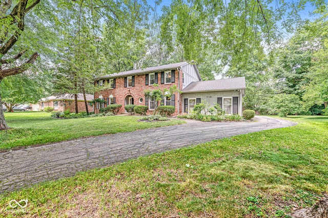 7138 Avalon Trail Ct, Indianapolis, IN 46250 - colonial home featuring asphalt driveway, brick siding, and a front yard