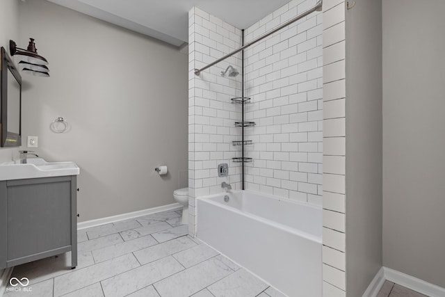 3447 Washington Blvd, Indianapolis, IN 46205 - bathroom with toilet, vanity, marble look tile flooring, baseboards, and shower / bath combination