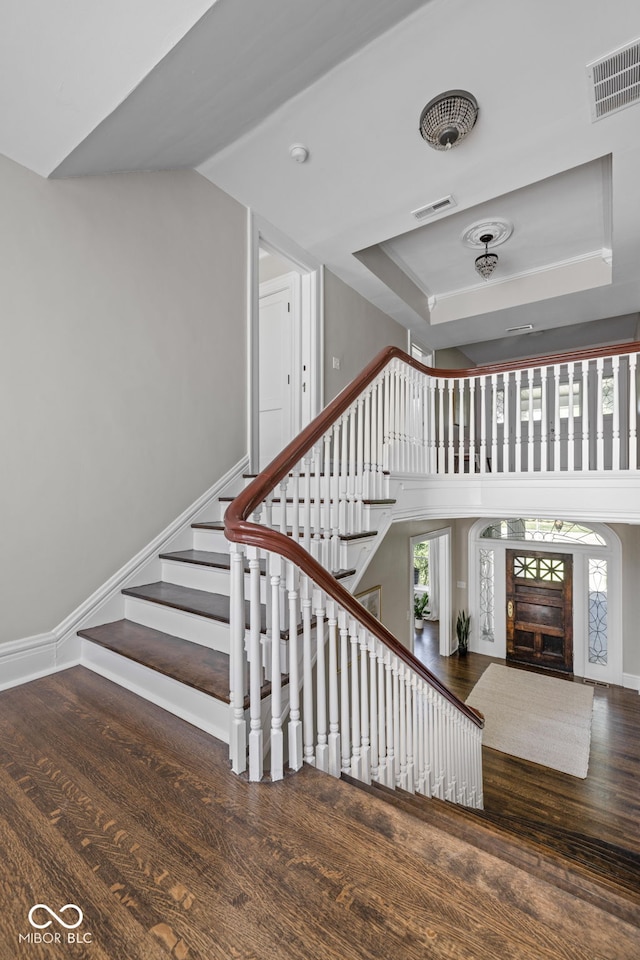 3447 Washington Blvd, Indianapolis, IN 46205 - stairs featuring wood finished floors, healthy amount of natural light, a raised ceiling, and baseboards