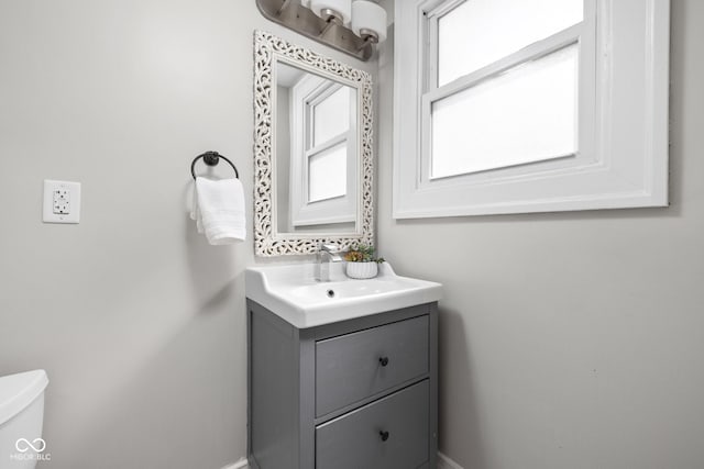 3447 Washington Blvd, Indianapolis, IN 46205 - bathroom with healthy amount of natural light, vanity, toilet, and baseboards