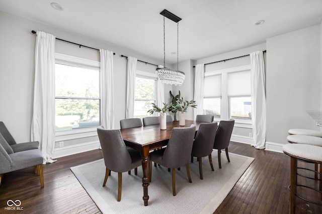 3447 Washington Blvd, Indianapolis, IN 46205 - dining space featuring dark wood-type flooring, baseboards, and a chandelier