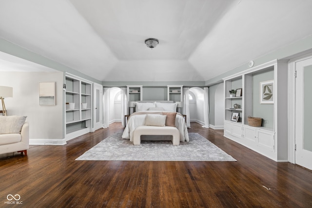 3447 Washington Blvd, Indianapolis, IN 46205 - bedroom featuring arched walkways, wood finished floors, lofted ceiling, and baseboards