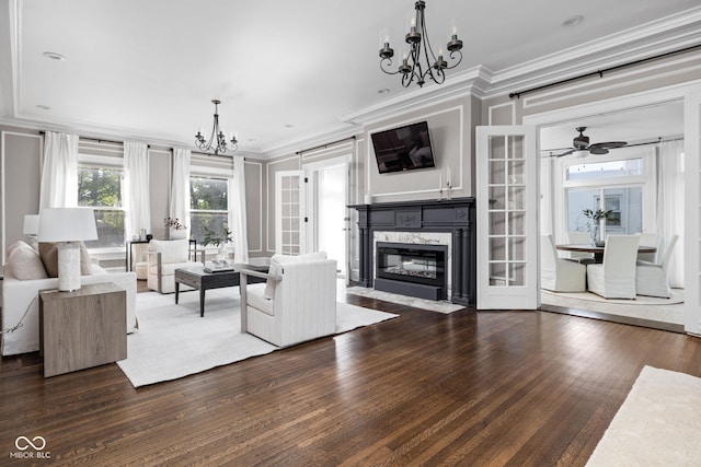 3447 Washington Blvd, Indianapolis, IN 46205 - unfurnished living room with a chandelier, crown molding, wood finished floors, a fireplace, and ceiling fan