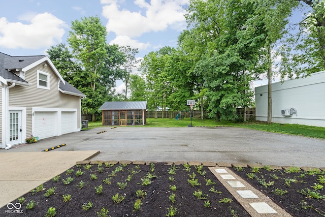 3447 Washington Blvd, Indianapolis, IN 46205 - view of patio / terrace featuring fence, driveway, and an attached garage