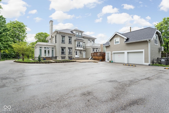 3447 Washington Blvd, Indianapolis, IN 46205 - view of front of property with a garage, a chimney, driveway, and a shingled roof