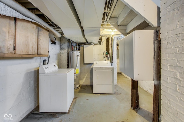 unfinished basement featuring washing machine and clothes dryer and gas water heater