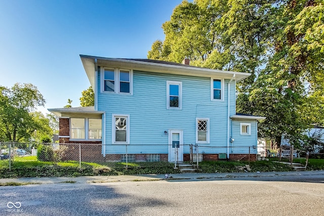 view of front of property featuring a fenced front yard and a chimney