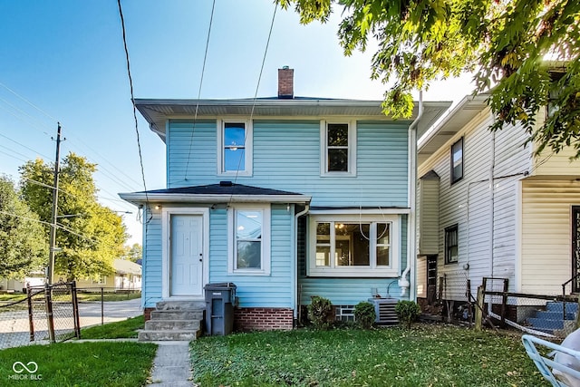 rear view of property featuring a chimney, fence, central AC, and entry steps